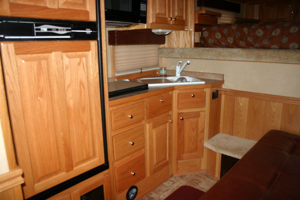 Oak Cabinets, Large fridge wi/freezer, two-burner cooktop, microwave etc...